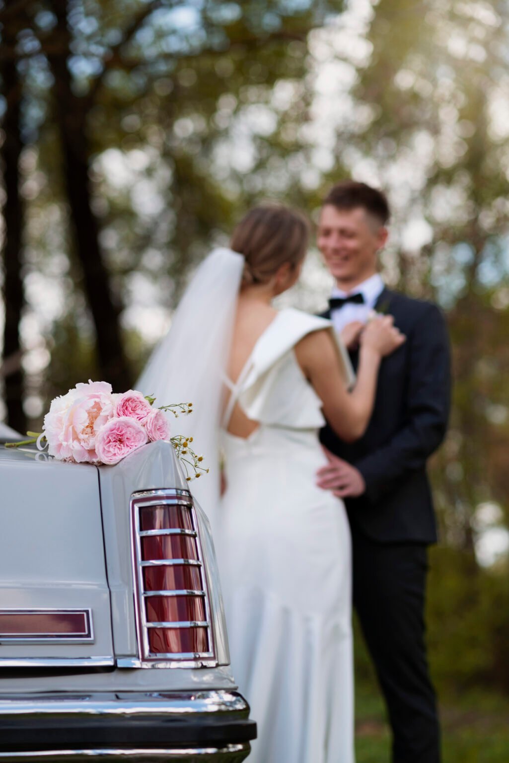 just-married-couple-with-their-car